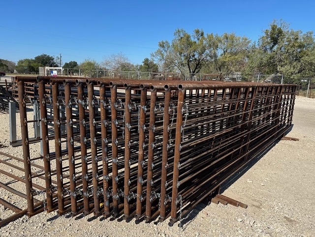 Stack of custom livestock corral panels ready for installation