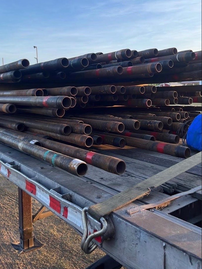 Steel pipe stock staged on a trailer for a welding and fabrication job