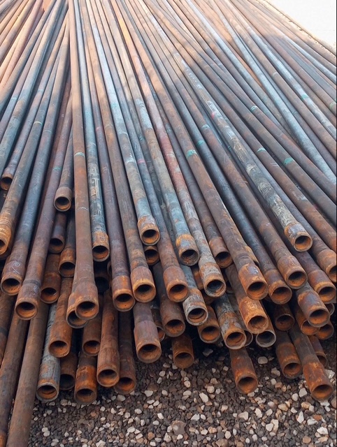 Fanned stack of raw steel pipe stock for fabrication work